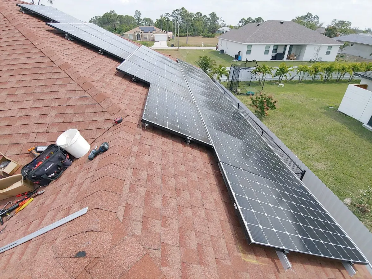 Solar panels reinstalled on a new shingle roof, aerial view