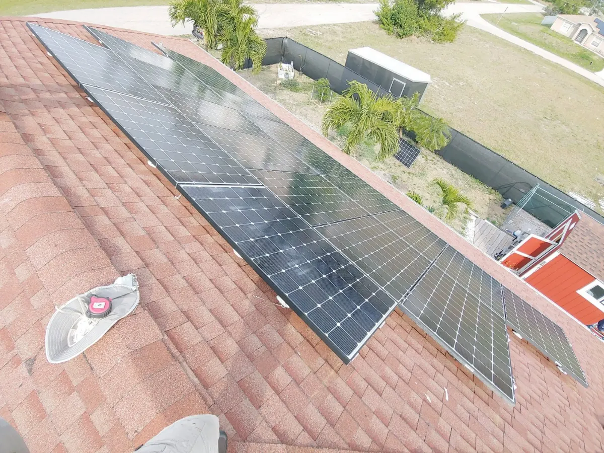 Solar array on a tile roof next to a pool